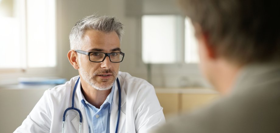 Doctor talking to patient in office